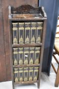 An early to mid 20th Century oak narrow bookcase , with set of Dickens novels published by Waverley