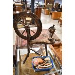 A traditional stained frame spinning wheel and accesories