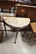 An early 20th Century half moon hall table with marble top