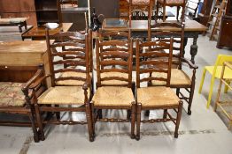A set of six (four plus two) oak ladder back dining chairs having rush seats