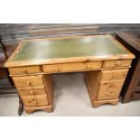A modern Ducal pine twin pedestal desk, of traditional design with green tool leather skiver.
