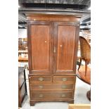 An Edwardian mahogany and inlaid linen press having panelled cupboard over two over three drawer