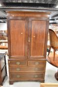 An Edwardian mahogany and inlaid linen press having panelled cupboard over two over three drawer