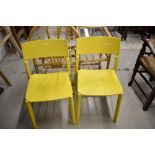 A pair of yellow plastic chairs