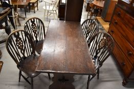 A set of four stained frame wheelback dining chairs and a similar refectory table