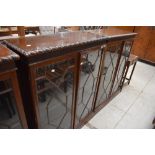 A pair of early 20th Century mahogany single height bookcases having astral glazed doors