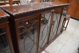 A pair of early 20th Century mahogany single height bookcases having astral glazed doors