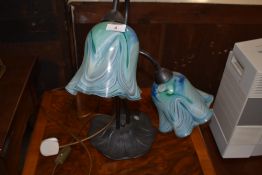A reproduction Art Nouveau style table lamp of stylised form with mottled glass shades