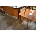 A vintage dining table, chairs and similar sideboard