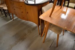 A vintage dining table, chairs and similar sideboard