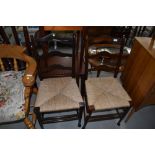 A pair of traditional rush seated ladder back chairs