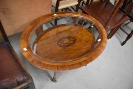 An Edwardian mahogany and inlaid oval coffee table, with inlay decoration