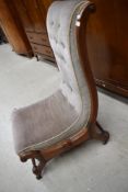 A Victorian low seat nursing chair in the savanarola style with later dralon upholstery, with turned