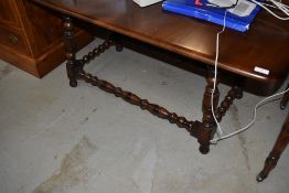 A reproduction oak coffee table having turned frame