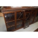 An early 20th Century mahogany single height double with bookcase having astral glazed doors