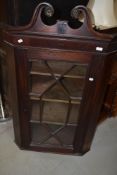 A 19th Century mahogany corner display cabinet having astral glazed door and line inlay decoration