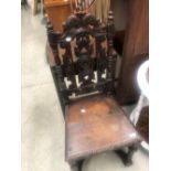 A period oak hall chair having carved decorations