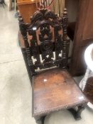 A period oak hall chair having carved decorations