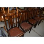 A set of four early 20th Century rail back dining chairs