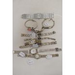 Ten ladies watches having silver tone straps.