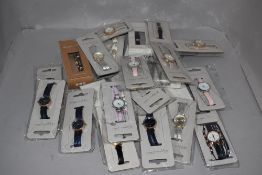 A collection of ladies fashion watches in various colours and designs, new in packaging