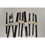 Ten girls/ladies fashion watches having black straps.