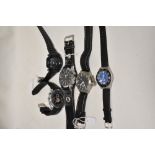 Five mens watches all having black straps.