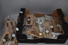 A selection of ladies fashion watches in various colours and designs, new in packaging.