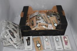 A large collection of ladies fashion watches in various colours and designs, new in packaging.
