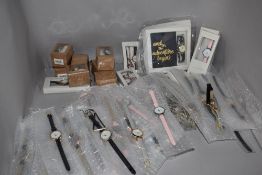 A large collection of ladies fashion watches in various colours and designs, new in packaging.