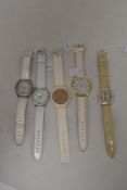 Five white strapped watches