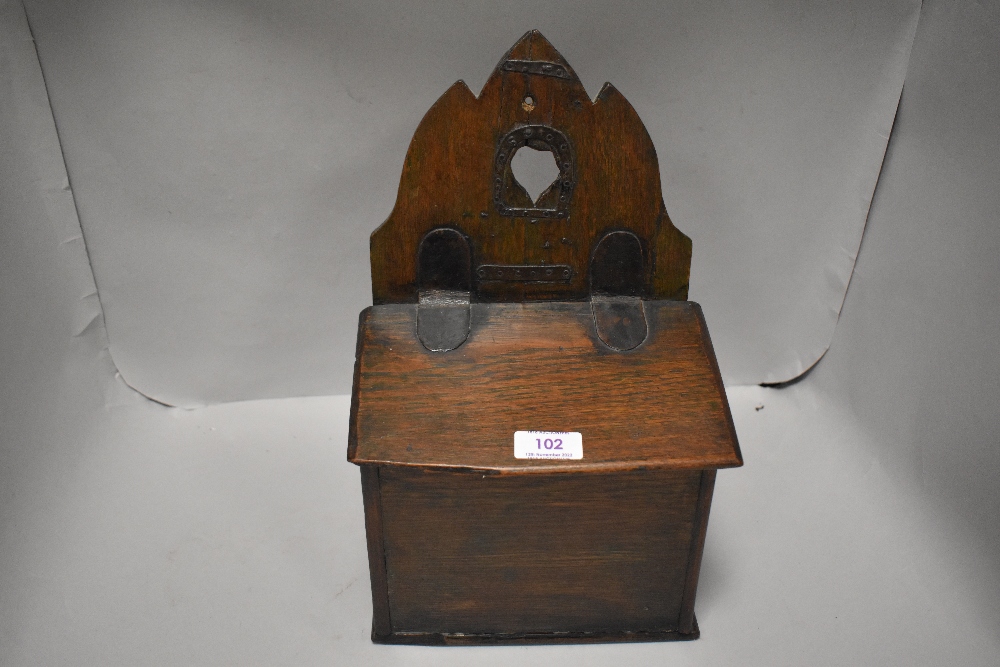 A late 18th century vernacular candle box in oak with leather hinge and banded strapwork