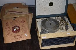 An early 20th century Emerson portable vinyl record player in a green case, with a selection of