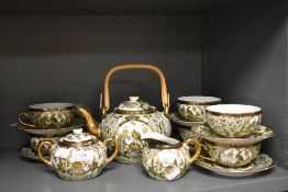 A modern Japanese Saji tea service in a gilt and green pattern