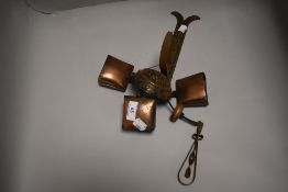 A set of 20th century copper cattle style bells with bracket fixing