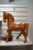 A large mid century wooden carved figure of a horse 53cm high