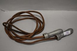 A set of vintage childrens skipping rope with metal handles stampes Title