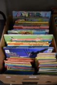 A box of vintage children's annuals and story books including Ladybird books, Dan Dare and Star