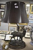 A modern Herredities style resin lamp base in the form of a stag with leather effect shade