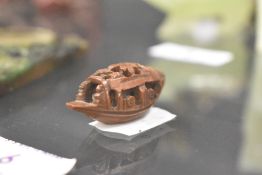 An early 20th century Japanese wooden carved Ojime bead in the form of a sailing boat or junk