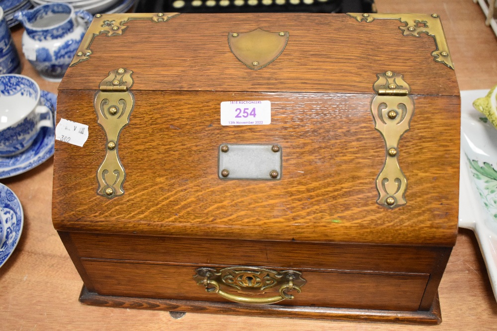 A fine Edwardian writers case in oak with brass banding and duel drawer and lid opening mechanism