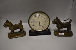 An Art Deco mantel clock having circular face with two cast Scottie dog door stops