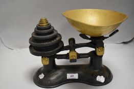 A set of early 20th century kitchen balance scales with weight set