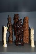 Four 20th century wooden carved oriental figures with two similar bone carved figures