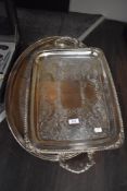 Two large plated trays, one having handles and of rectangular form, the other oval with