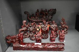 A selection of 20th century resin cast Chinese figures including dragon boat, Imperials and temple