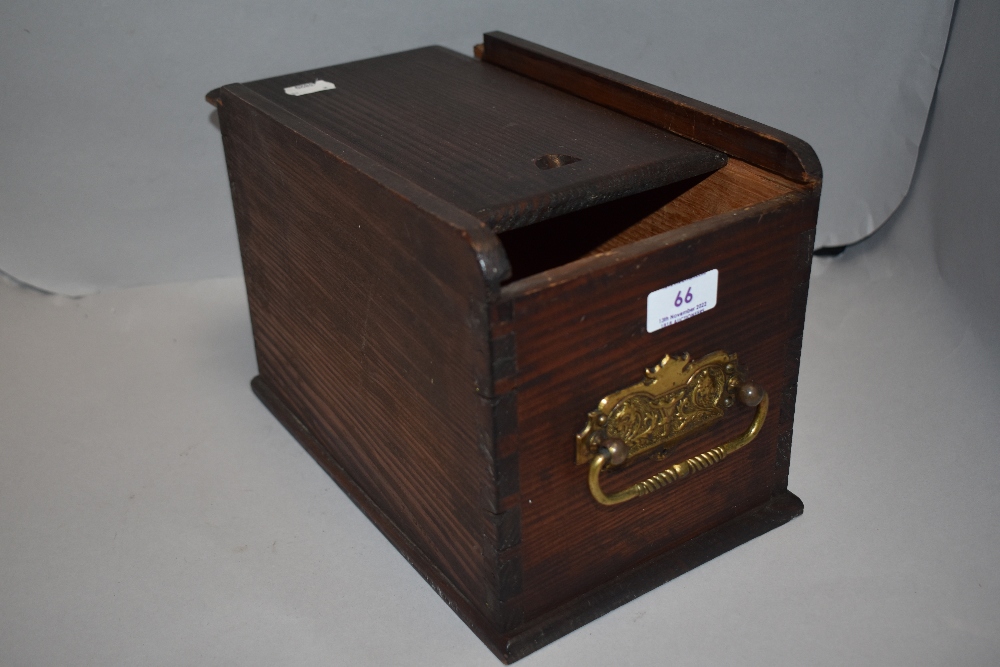 A vintage pine storage box with brass handle and sliding lid