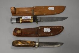 Two mid century horn handled dagger style knives with leather scabbards