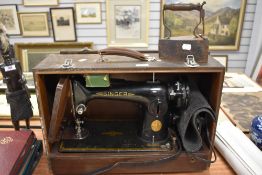 A Singer sewing machine, model number BF501870 and a flat iron.