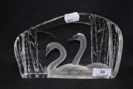 A modern M Jonasson Art glass paper weight with an image of swans